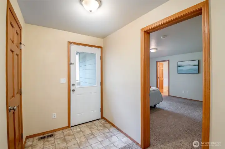 Back door primary exit to backyard and outdoor patio deck.