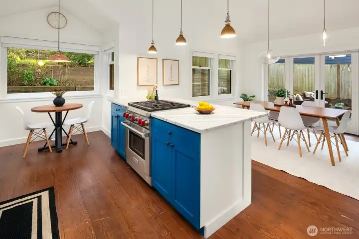 Bright kitchen with Carrera marble counters, Wolf Gas Range, stainless appliances, walk in pantry.... a wonderful entertainers kitchen and dining area!