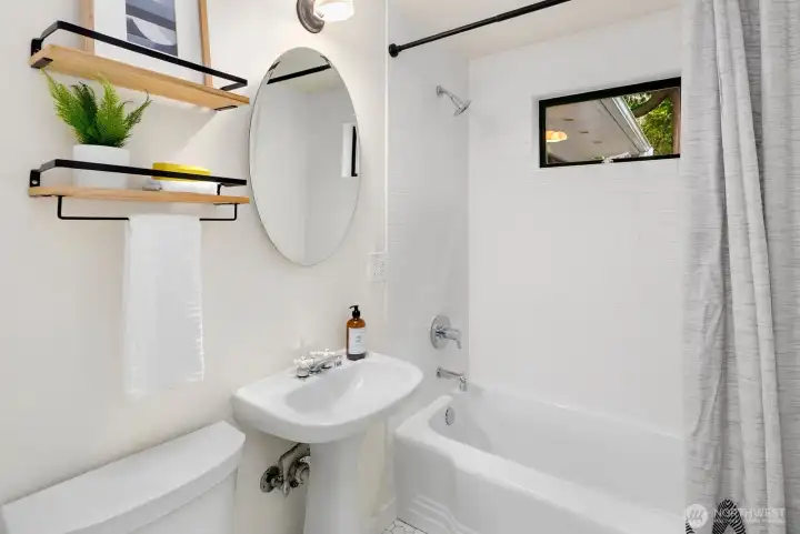 Updated full bathroom on main floor between bedrooms., features heated floors.