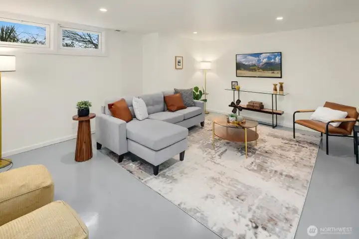 Lower level great room with modern sleek epoxy covered concrete floors for low maintenance and modern design.