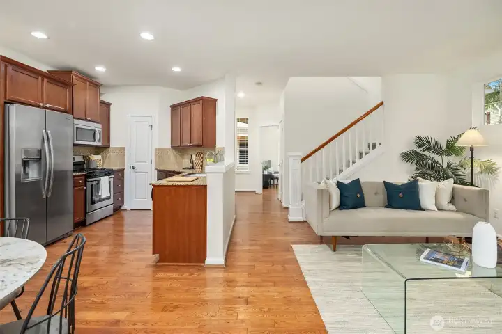 Open kitchen with granite counters and SS appliances and a pantry. All this opens to the living room and dining area. Nice big slider leads out the private patio/yard.