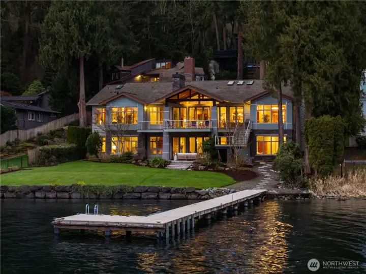 101’ of level Lake Washington waterfront with a 99’ deepwater dock, manicured lawn, and seamless indoor-outdoor living.