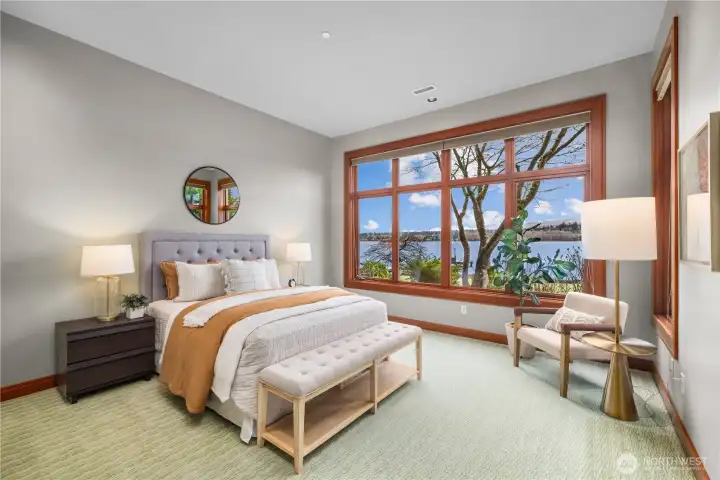 A peaceful retreat framed by the lake—this light-filled bedroom offers front-row views of the water, where mornings begin softly and evenings wind down in quiet, natural beauty.