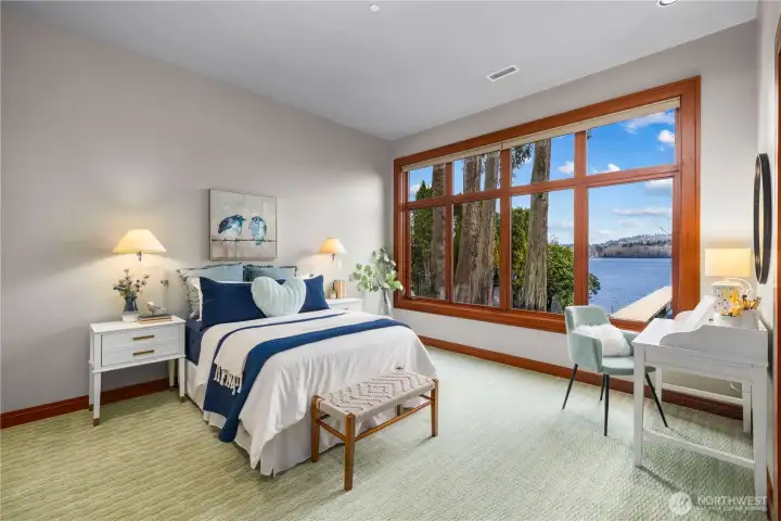 Wake up to the water—this light-filled bedroom offers peaceful lake views and a front-row seat to every sunrise.