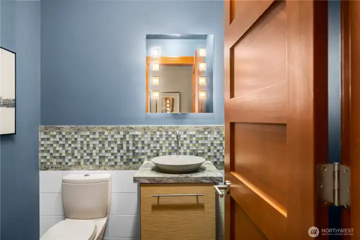 A refined lower level powder room with custom finishes, statement tilework, and warm wood elements that elevate the space.