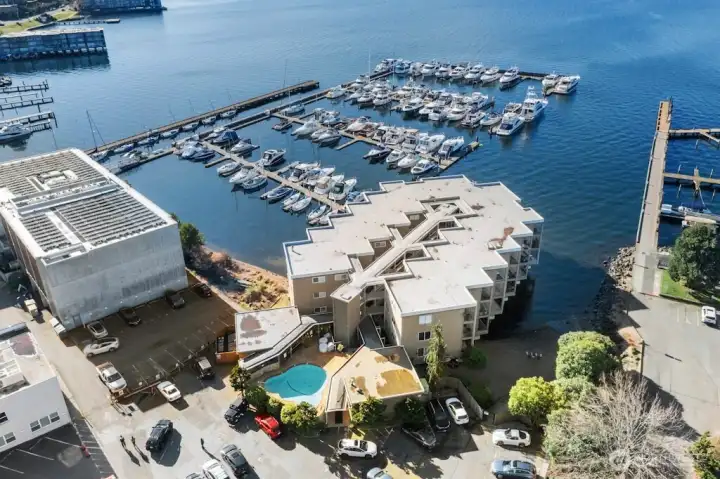 The quiet, vintage mid-century waterfront community (42 units) is built out over the water and offers exceptional amenities, including a pool, private sandy beach, individual storage, and designated parking.