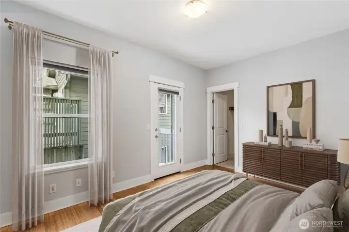 Private second bedroom suite with clawfoot soaking tub, walk-in closet, and access to a small outdoor deck.