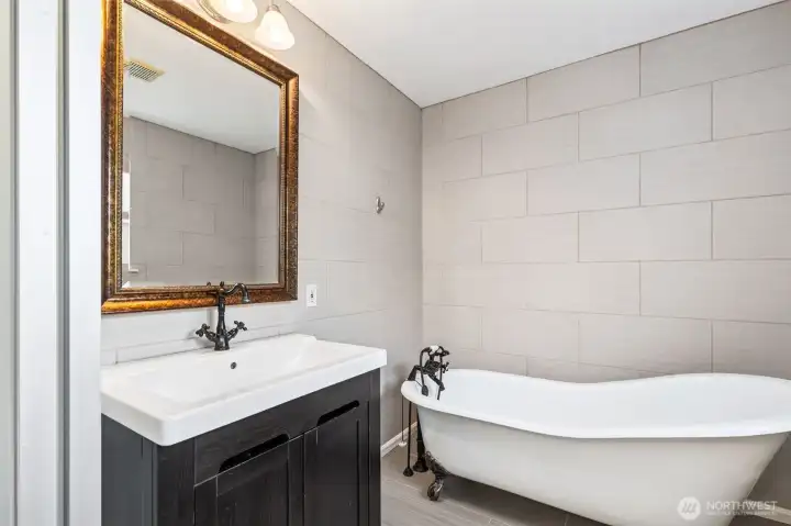 Charming bathroom featuring a clawfoot soaking tub perfect for unwinding.