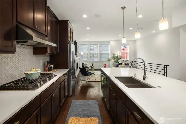 Timeless tile backsplash, simple pendant lights and a HUGE island make cooking enjoyable.