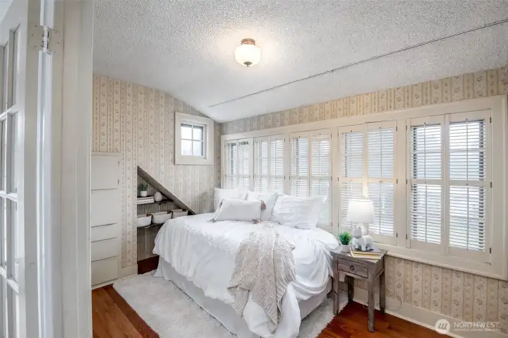 Enjoy built-in drawers and a pull down desk in this light filled room