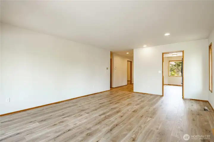 From living room, open door in the background is Bedroom#2. Hallway to the left goes to the primary, laundry room, and bathroom.