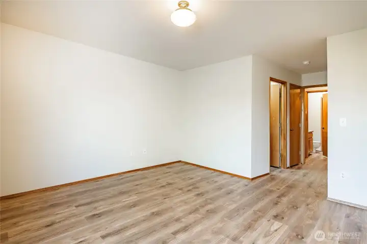 Primary Bedroom. Bathroom is first door to the left followed by a linen closet then the laundry room then main bathroom that has two doors, one connected to bedroom #2 and the other off the hallway.