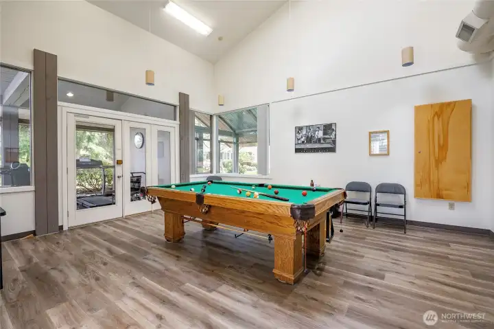 Clubhouse pool table and exercise room beyound.