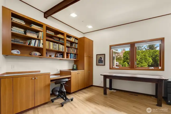 A large office with a built in desk and a murphy bed on the opposite wall for extra guests. A large office with a built in desk and a murphy bed on the opposite wall for extra guests.