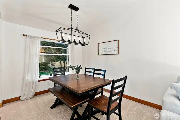 Sun-drenched dining room with a cozy nook overlooking the landscaped backyard. Sun-drenched dining room with a cozy nook overlooking the landscaped backyard.