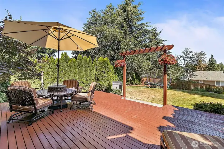 Expansive entertainer's deck with ample space for outdoor seating and dining, perfect for hosting gatherings. Expansive entertainer's deck with ample space for outdoor seating and dining, perfect for hosting gatherings.