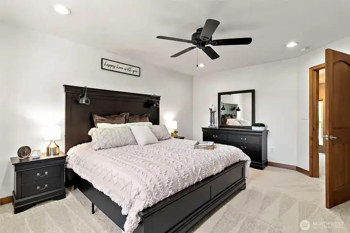 Primary bedroom with ceiling fan. Primary bedroom with ceiling fan.