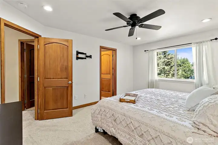 Spacious primary bedroom featuring a stunning view of the backyard. Spacious primary bedroom featuring a stunning view of the backyard.