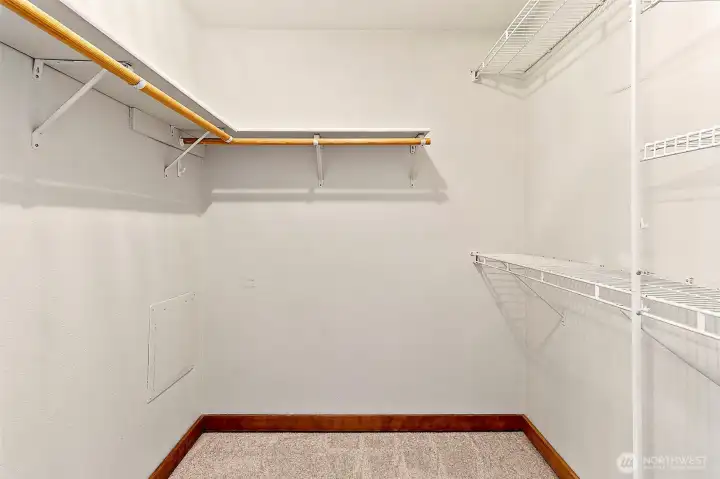 Spacious primary bedroom featuring a large walk-in closet. Spacious primary bedroom featuring a large walk-in closet.