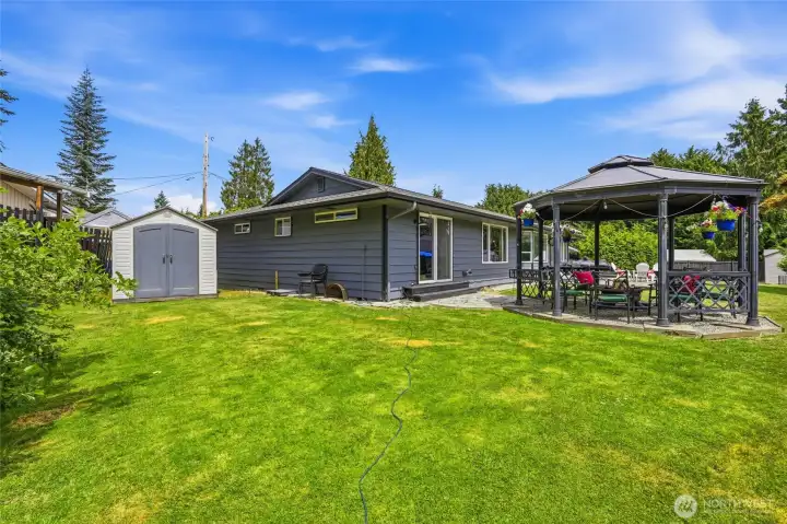back left section of yard, with 1 of the 2 very nice sheds that remain with the home, as well as the gazebo