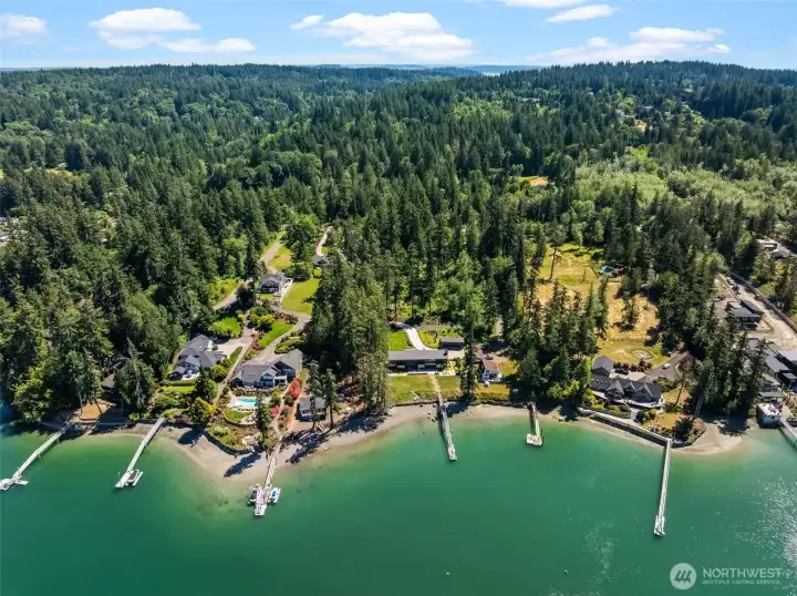 Aerial view captures the natural beauty of the shoreline and surrounding residential area. Aerial view captures the natural beauty of the shoreline and surrounding residential area.