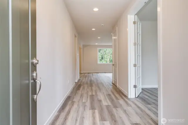 Photo not from actual home. Front door opens to wide entry