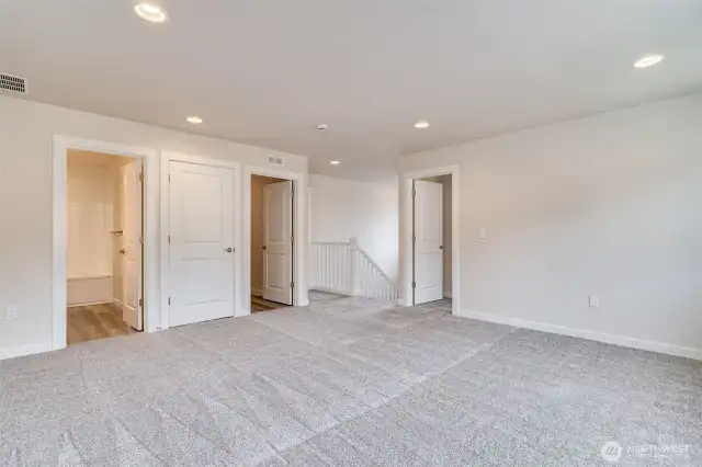 Photo not from actual home. Upstairs loft opens to laundry and bedrooms.