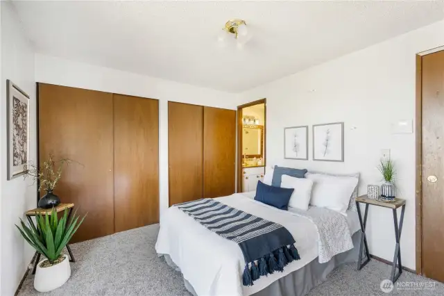 Shown here is the primary suite of the home. It features a wall of closets, a private bath, and its own balcony!