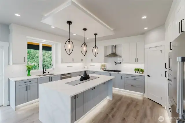 Large kitchen with waterfall quartz countertops