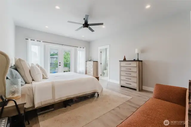 Large primary bedroom with french doors to south facing upper deck
