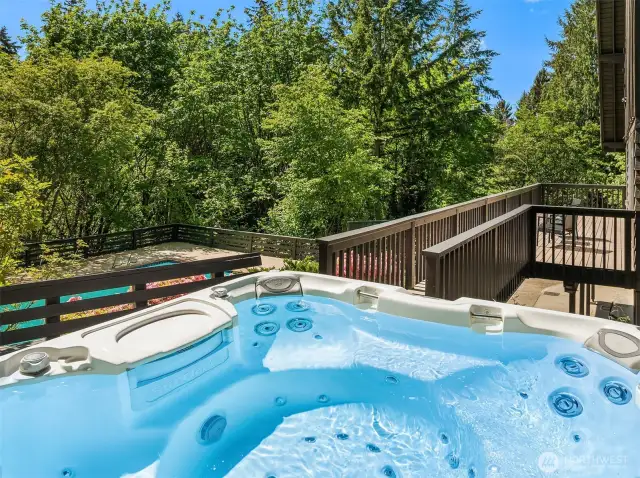 Unwind in the hot tub while enjoying a peek-a-boo view of Lake Sammamish, offering the perfect blend of relaxation and natural beauty.