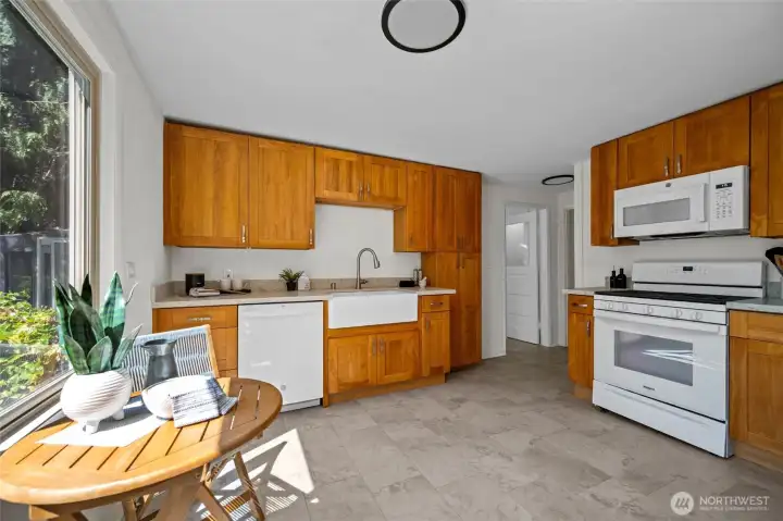 The heart of the home- this warm and inviting kitchen features a farmhouse sink, ample storage, and plenty of counter space for cooking and gathering.