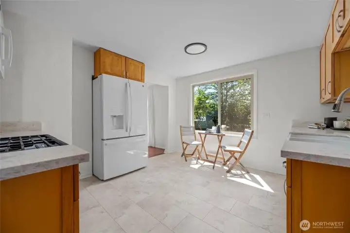 Start your day with coffee in this cheerful kitchen nook, bathed in natural light and surrounded by peaceful garden views.