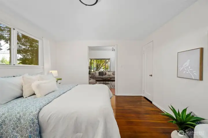 The primary bedroom offers a cozy retreat with direct access to the main living area, creating a seamless flow throughout the home