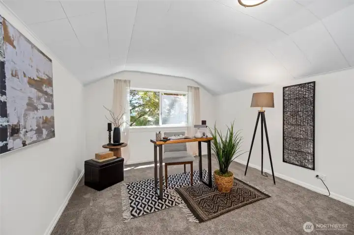 A bright and peaceful space- perfect for a home office, creative studio, or third bedroom with charming architectural details and treetop views.