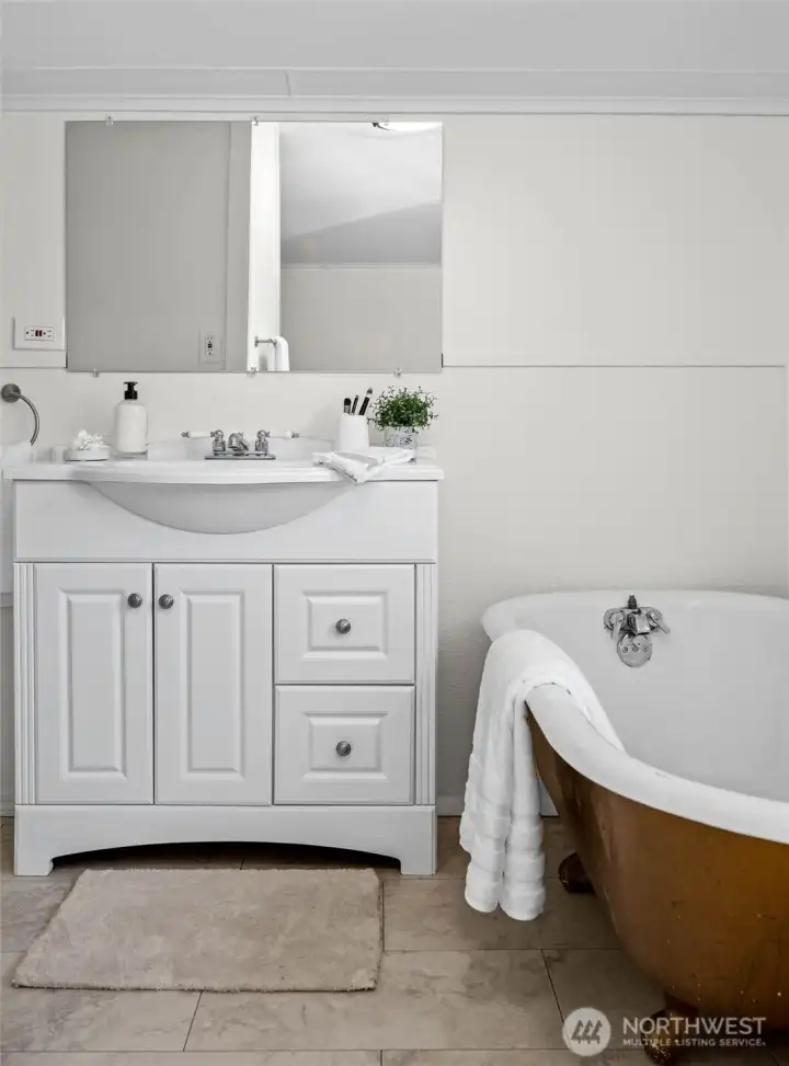 This upstairs bath combines vintage character with practical updates, offering a quiet spot to soak and unwind.
