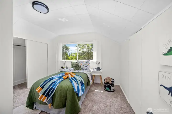 Another inviting upstairs bedroom with soft carpeting and playful charm, feels like a cozy treehouse retreat.