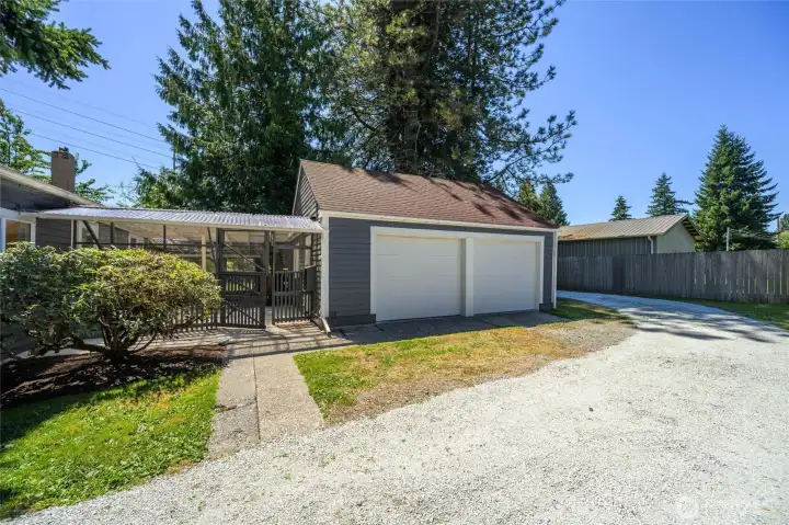 Spacious detached two-car garage with additional shop space, plus a covered breezeway for year-round convenience and easy access to the home.