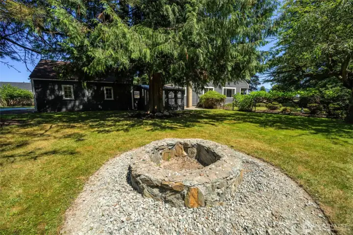 A view of the secluded garden area and fire pit, perfect for peaceful afternoons or playtime with pets.