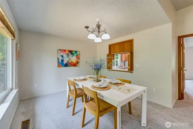 Take a look at that Dining Room! This is a large table and there is still so much space. Notice the passthrough between the Kitchen and Dining Rooms. How convenient!