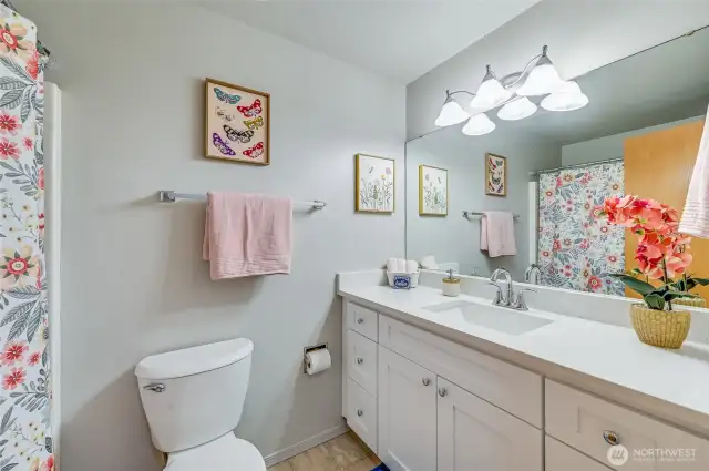 Directly across from the first bedroom we find the updated, full sized, main bathroom. New vanity with quartz countertops and tons of extra storage, fresh paint, and a tub shower combo complete this space. Oh and yes, there is a toilet too!