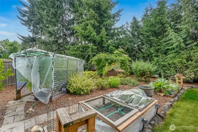 A true gardener's paradise! Your vegetable garden is fully set with a watering system making growing even easier. Notice the tomato hot house? It grows incredible tomatoes for your enjoyment.