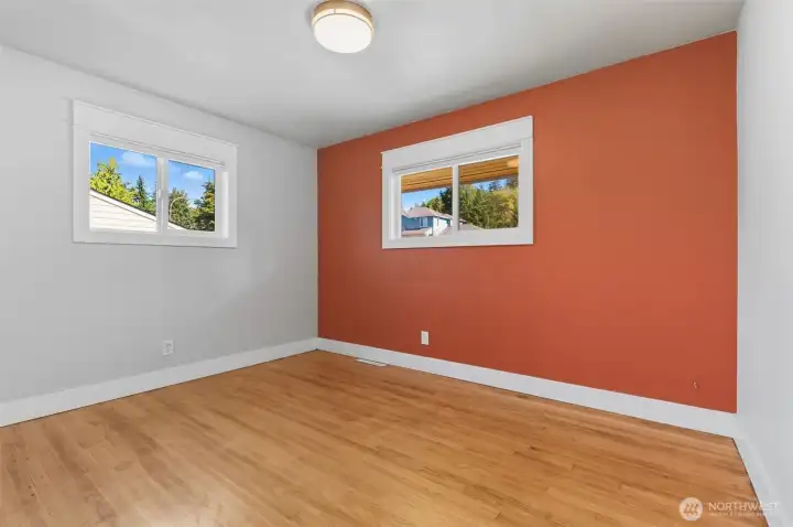 Primary bedroom with tasteful accent wall