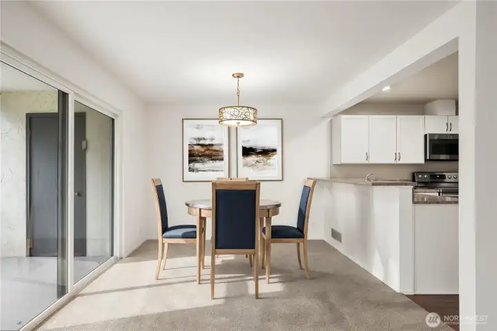 dining space, breakfast bar & entry to large deck *virtually staged*