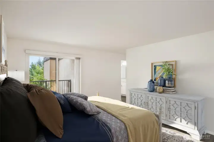 Primary bedroom has access to it's own bathroom, walk-in closet & private balcony *virtually staged*