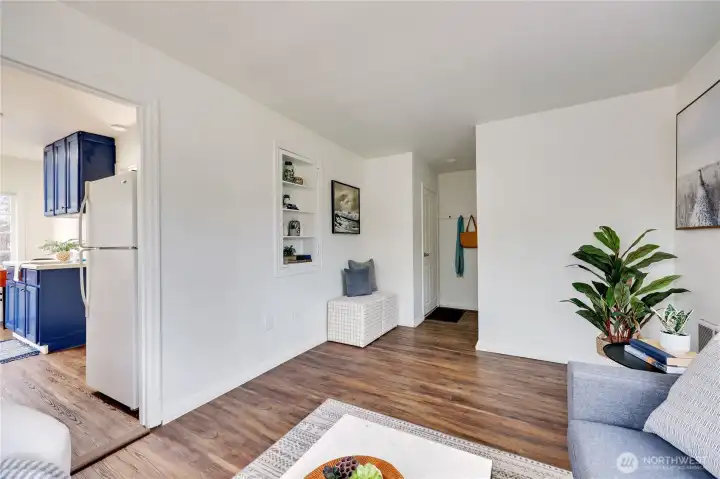 #4 Living room w/ doorway to kitchen on left and entry and bathroom on the right
