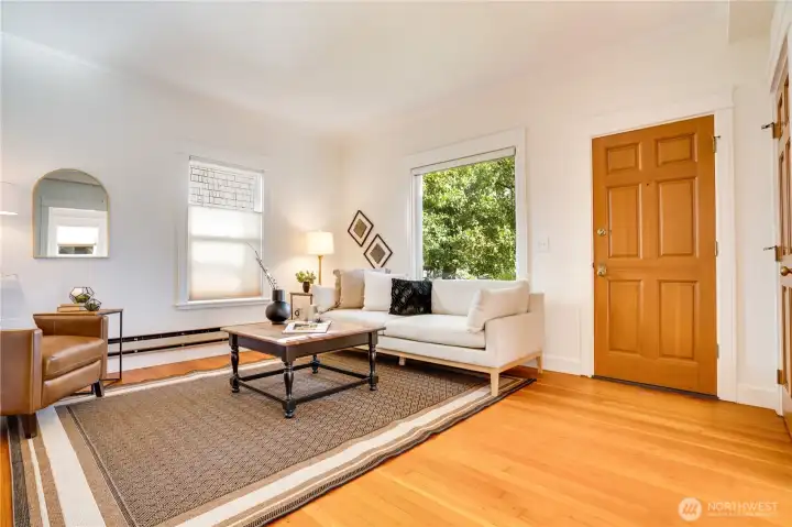 Living room with fir floors, fireplace, 9’ ceilings and east facing picture windows for the best morning light.