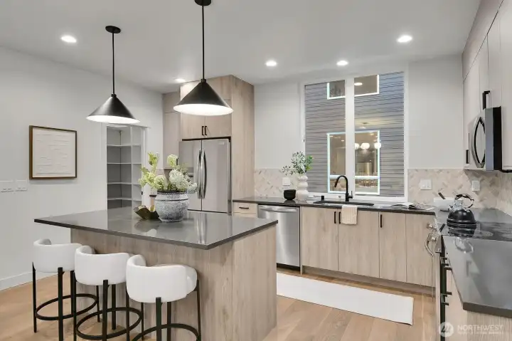 The full size kitchen features an island with seating,