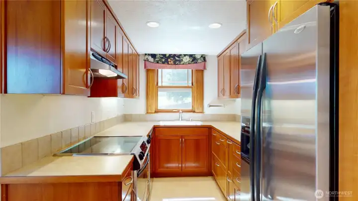 Custom Cherry Kitchen Cabinets with stainless appliances & custom windows with built in screens an shades!