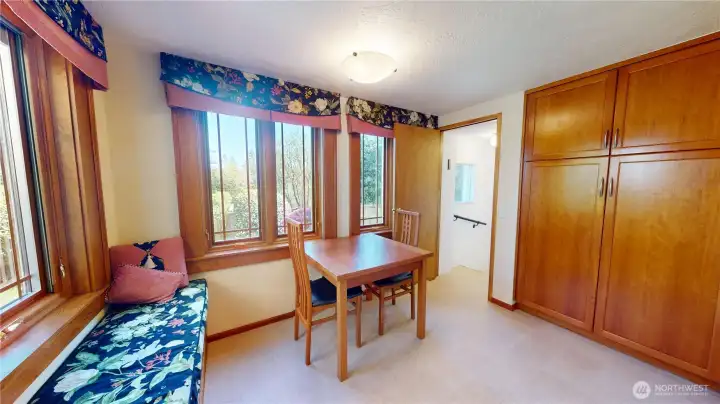 Kitchen nook & pantry with built-in bench seat. Custom windows with built in screens and shades! Doorway leads to the downstairs.